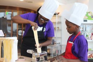 Mom helping son with pasta at Mommy and Me class