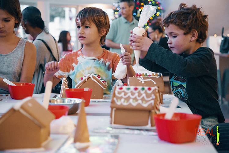 Kids enjoying the Gingerbread House Decorating class at The Real Food Academy