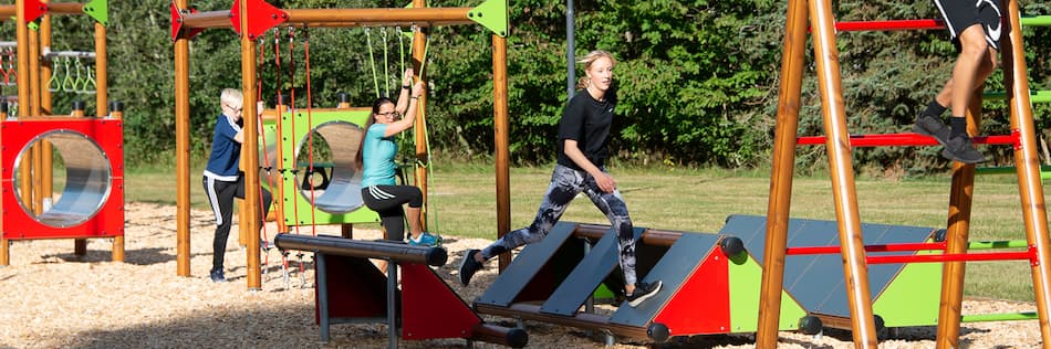 Image of kids playing on an outdoor obstacle course